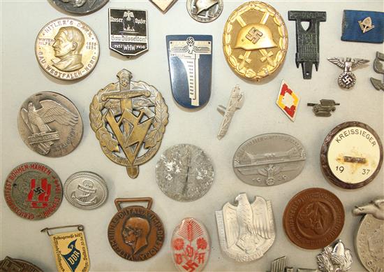 A large collection of various German Third Reich badges,